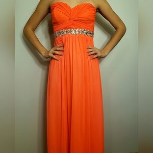A neon pink/orange long formal dress with gem waistband.